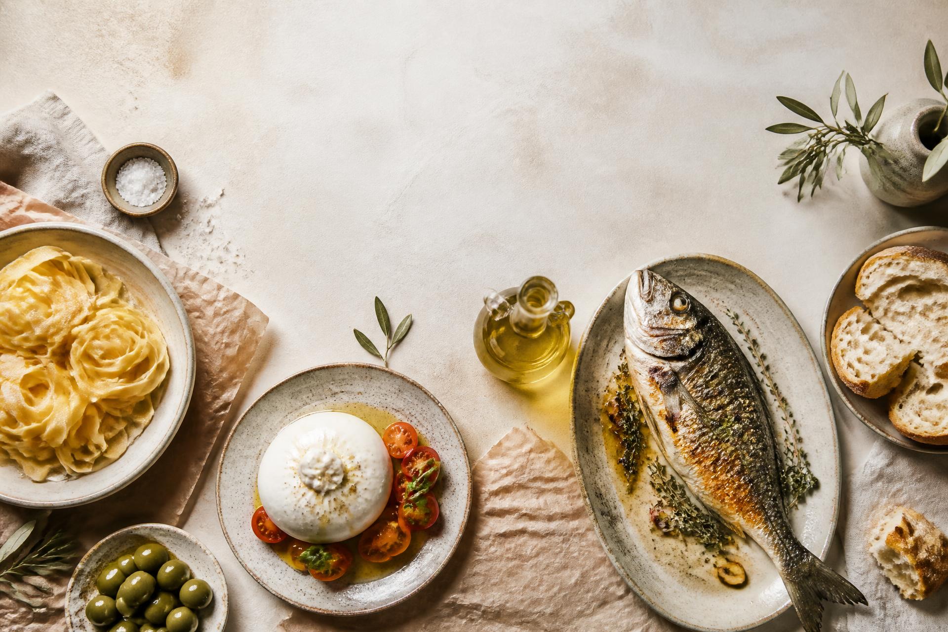 Overhead spread of Sapore Express dishes — fresh pasta, burrata, whole roasted fish and olive oil